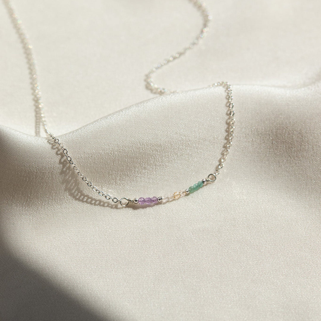 Necklace with small beads on a light fabric background