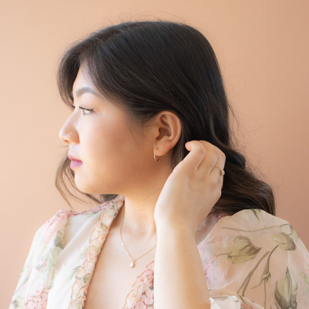 Woman wearing a floral dress against a beige background